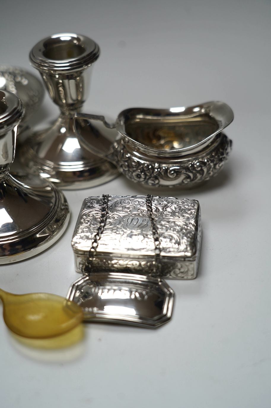 A group of mixed silver including a five bar toastrack, pair of dwarf candlesticks, 19th century snuff box, ring tree dish, cream jug, etc. Condition - poor to fair